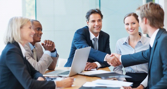 2 men wearing suits shaking hands