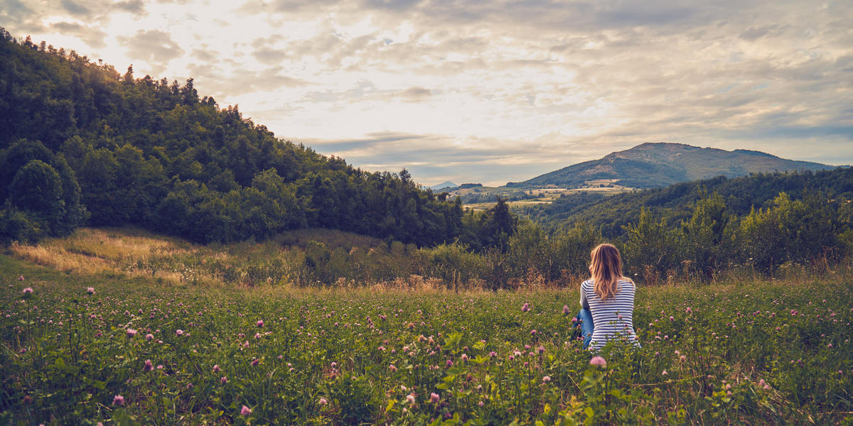 woman hiking in flower field